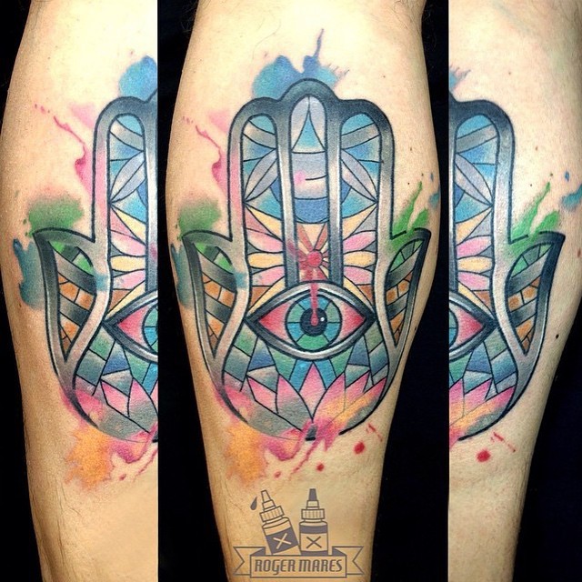 Watercolor style colored leg tattoo of Hamsa hand