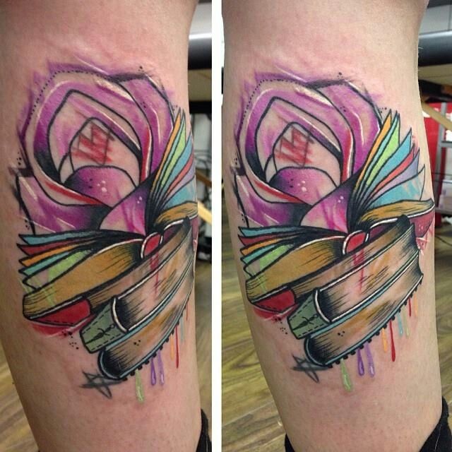 Watercolor style colored leg tattoo of books with flowers