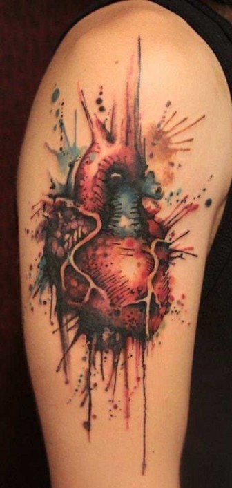 Watercolor style colored shoulder tattoo of human heart
