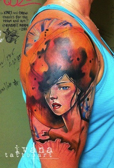 Watercolor style colored shoulder tattoo of woman face with big hairstyle