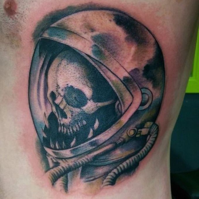 Watercolor style colored side tattoo of human skeleton with space suit