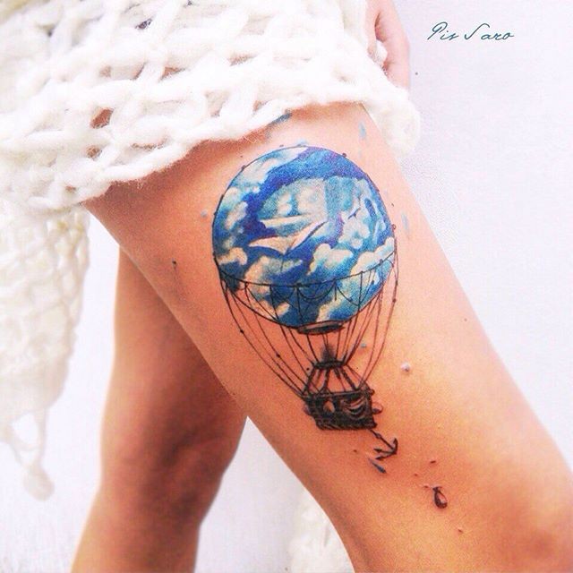 Watercolor style colored thigh tattoo fo flying balloon with anchor