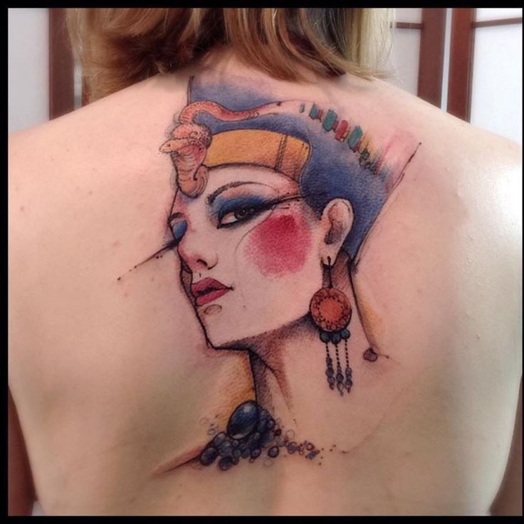 Watercolor style cool looking upper back tattoo of ancient Egypt queen