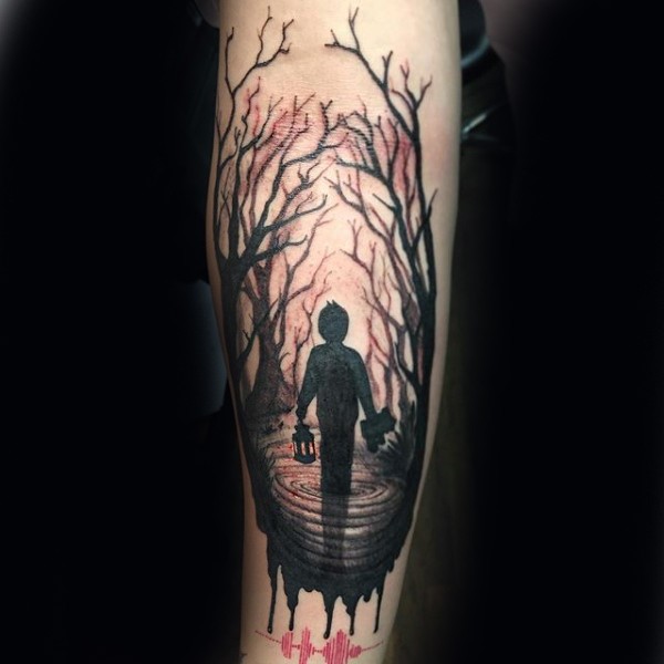 Watercolor style creepy forearm tattoo of boy with lighter in dark forest