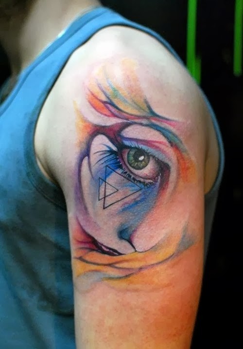 Watercolor style cute looking shoulder tattoo of woman eye stylized with triangles