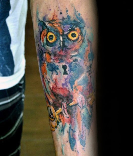 Watercolor style forearm tattoo of owl stylized with keyhole