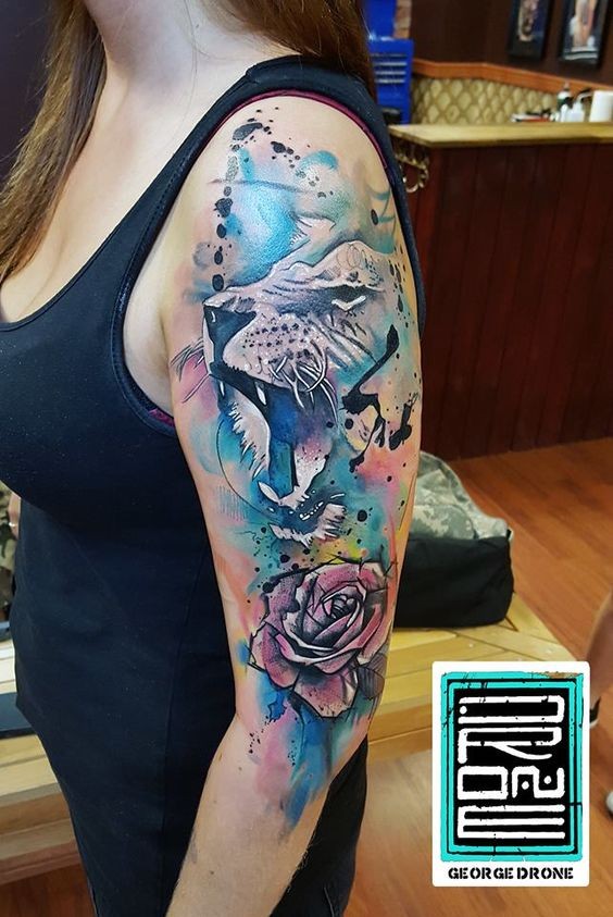 Watercolor style large half sleeve tattoo of lion with rose