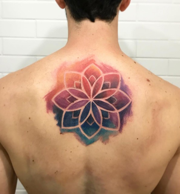 Watercolor style nice looking upper back tattoo of big beautiful flower