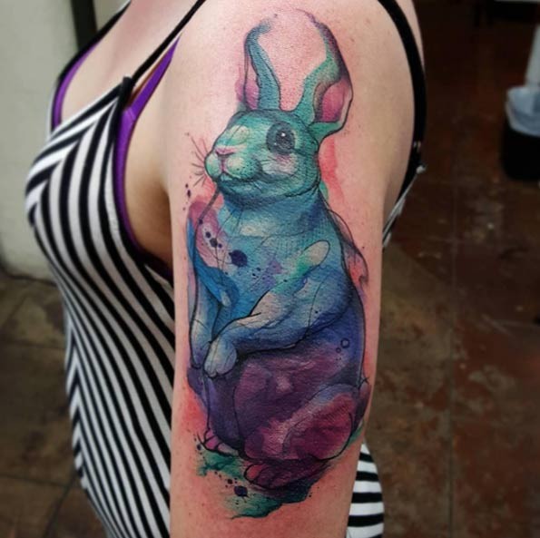 Watercolor style painted cute rabbit tattoo on shoulder