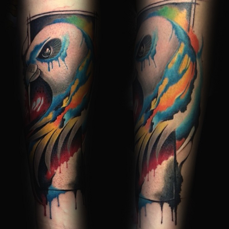 Watercolor style painted forearm tattoo of beautiful colored bird