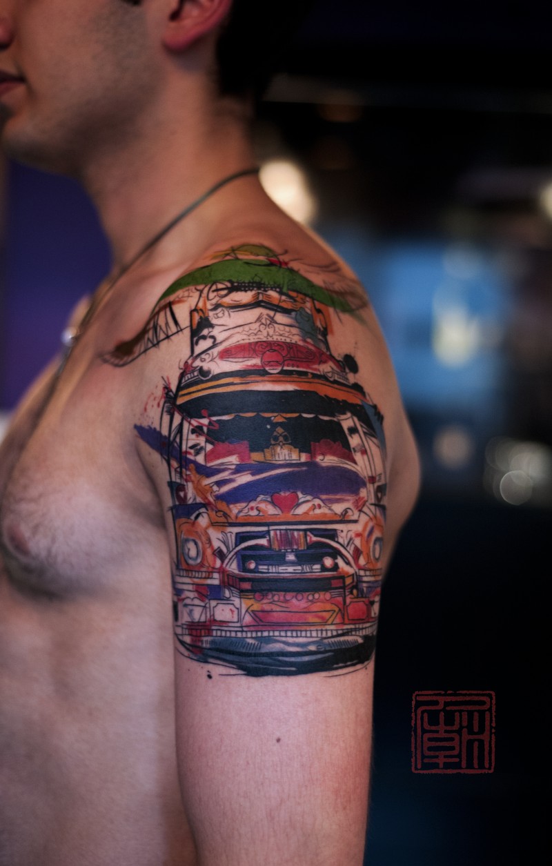 Watercolor style painted incredible car tattoo on shoulder