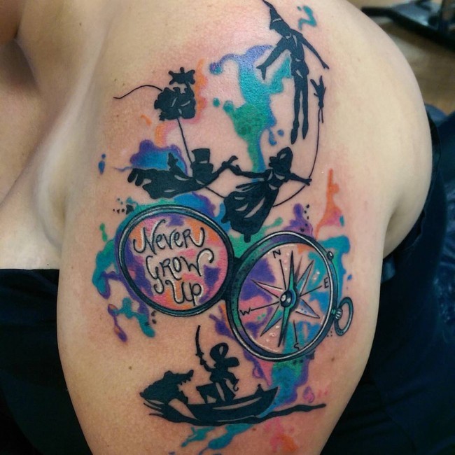 Watercolor style shoulder tattoo of colored Peter Pan and compass