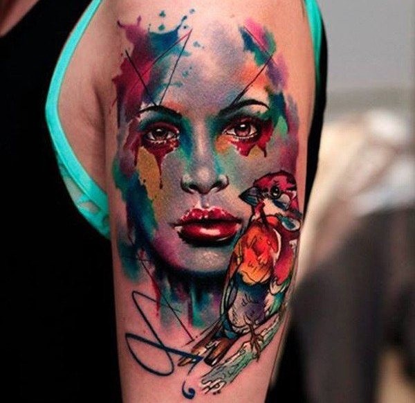 Watercolor style shoulder tattoo of woman face with birds
