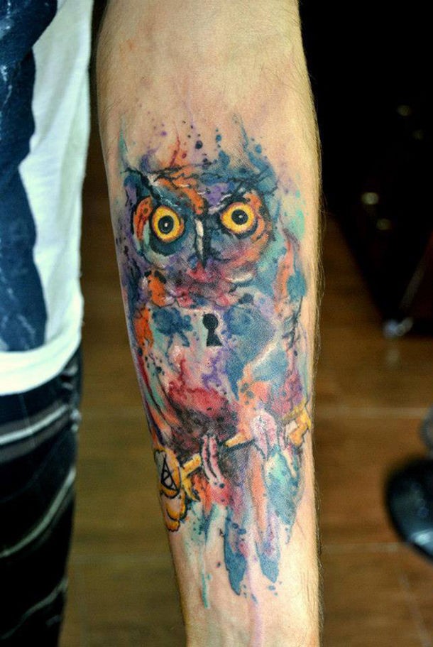 Watercolor tattoo owl on arm