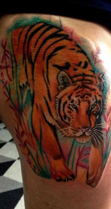 Watercolor tiger tattoo on thigh