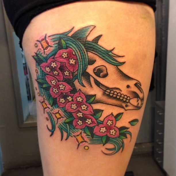 Weird original design horse skull with floral wreath colored thigh tattoo with sparkls