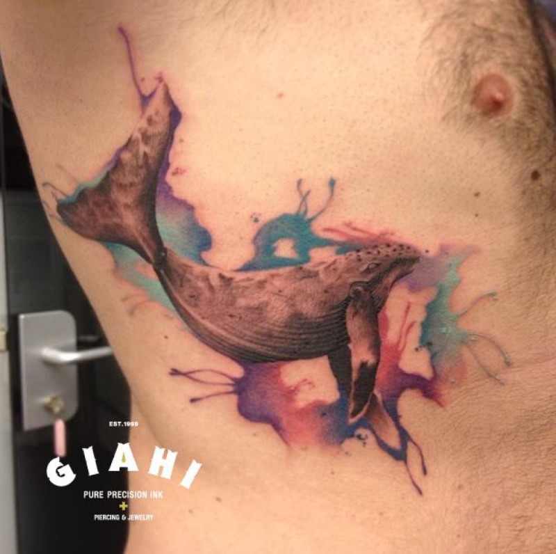 Whale with wide open jaw tattoo on side with colored watercolor paint drips