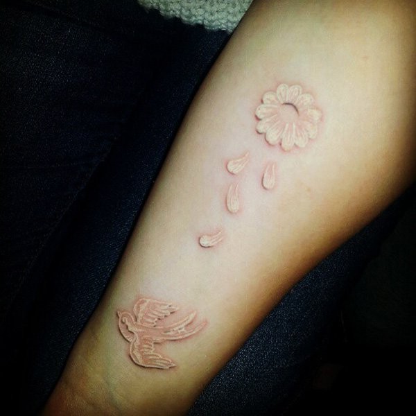 White ink bird and flower tattoo