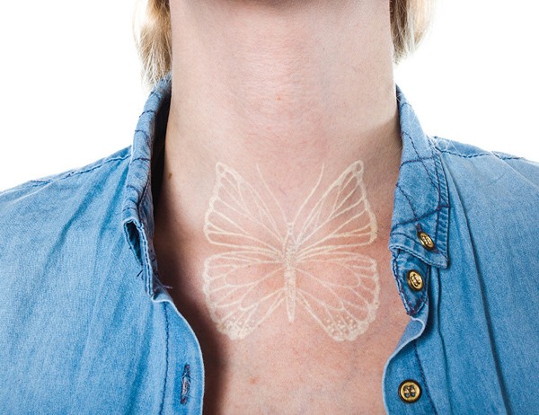 White ink butterfly tattoo on neck