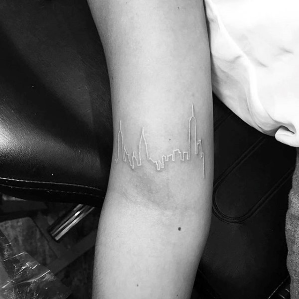 White ink castle shaped thin line tattoo on arm