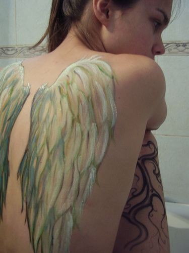 White wings tattoo on back for girls