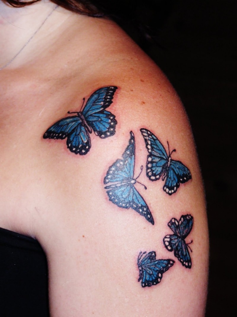 White with blue small butterfly tattoo on shoulder