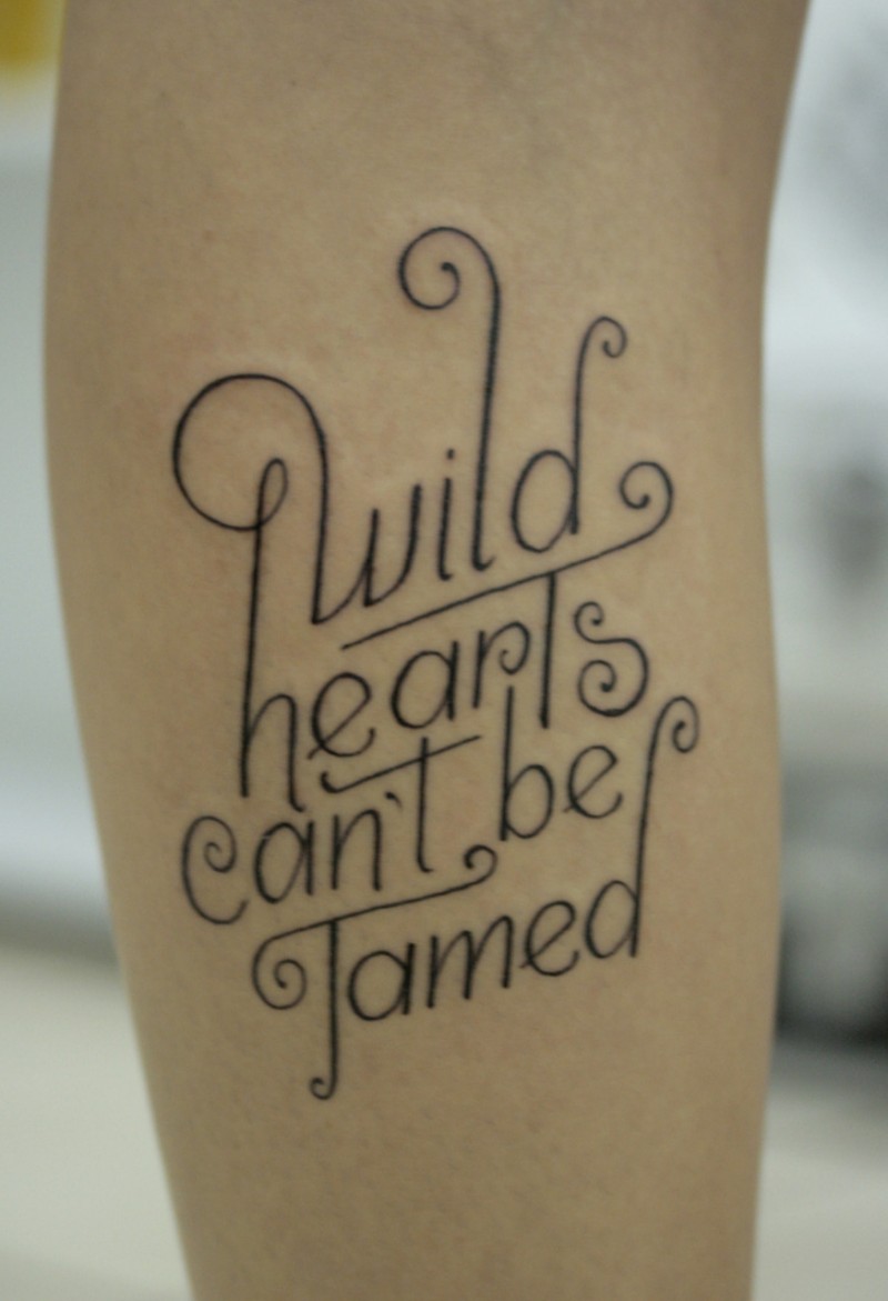 Wild hearts cant be tamed quote tattoo on arm