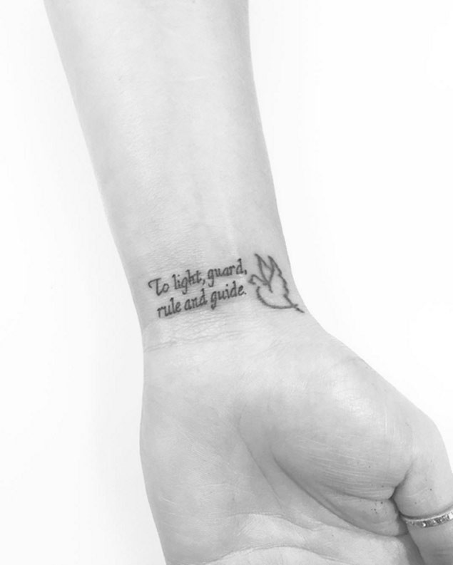 Wise thin lettering and tiny white pigeon wrist tattoo