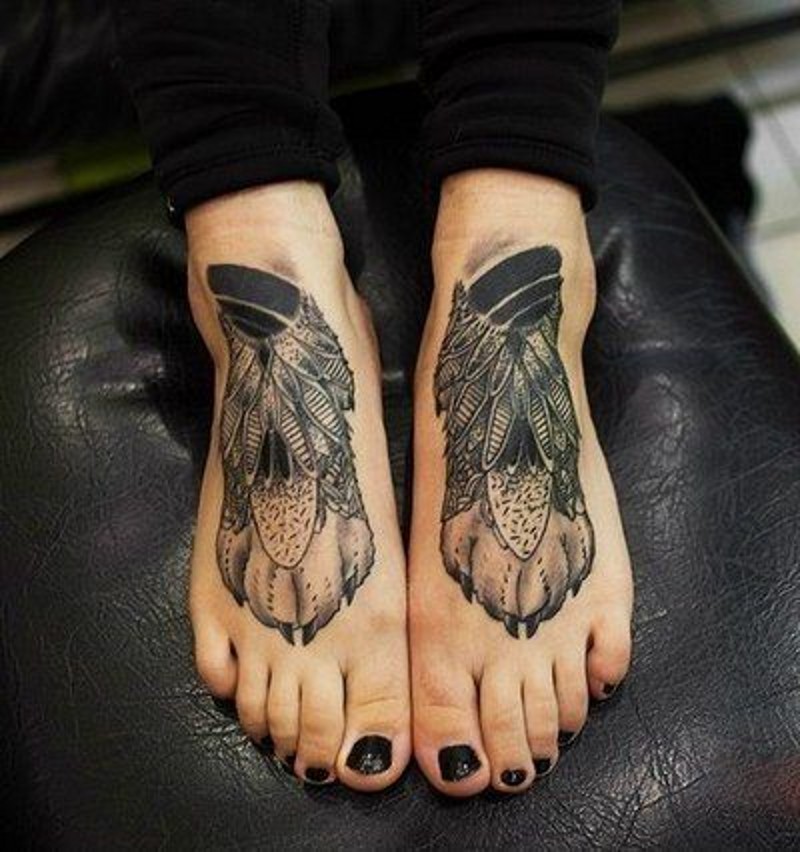 Wolf paw with feathers tattoo on feet