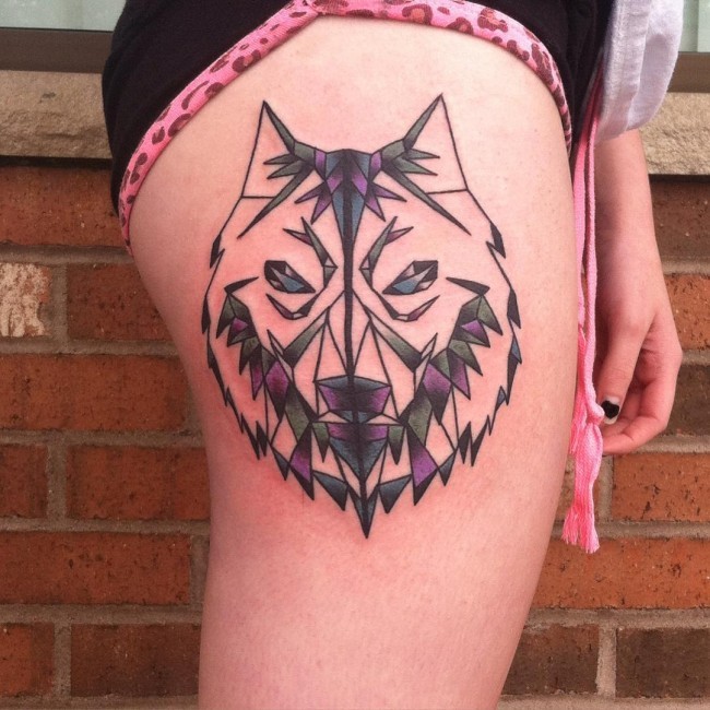 Wolf&quots head colored thigh tattoo in geometrical style