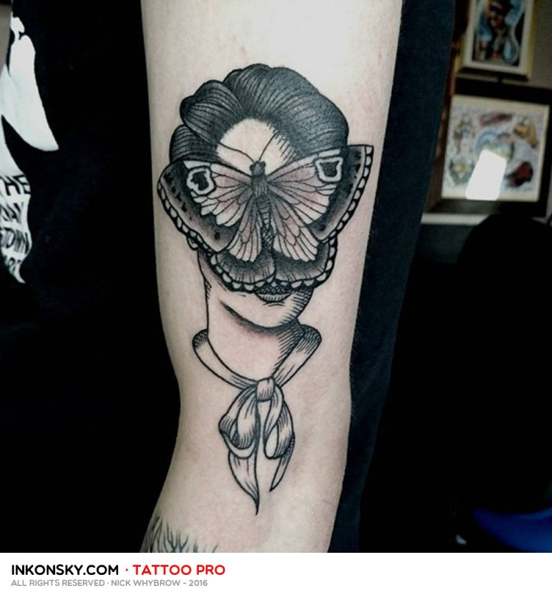 Woman&quots portrait with butterfly on fave black and white biceps tattoo in surrealism style