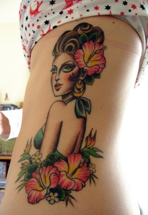 Woman and hibiscus flowers tattoo on ribs
