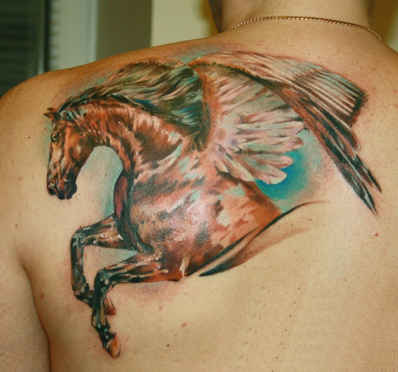 Wonderful coloured dark horse pegasus tattoo on shoulder blade