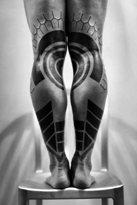 Wonderful designed black ink tribal ornaments tattoo on legs