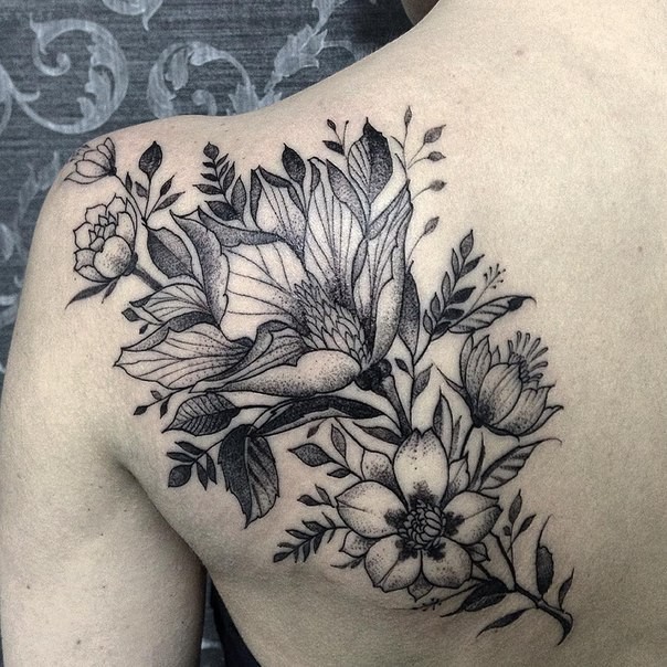 Wonderful flowers tattoo on woman&quots shoulder blade in engraving style