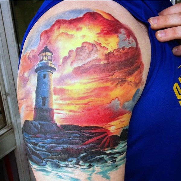 Wonderful multicolored lighthouse shoulder area tattoo with sunset