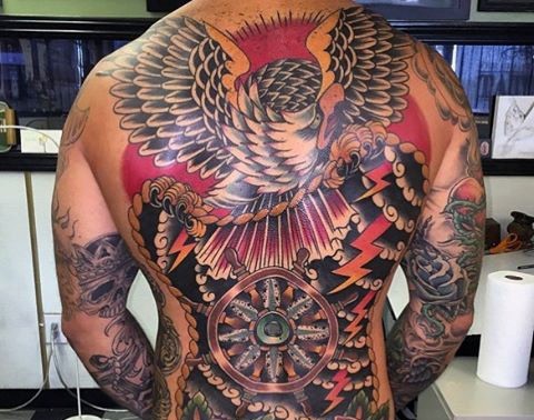 Wonderful nautical themed massive colored tattoo with eagle and ship steering wheel on whole back