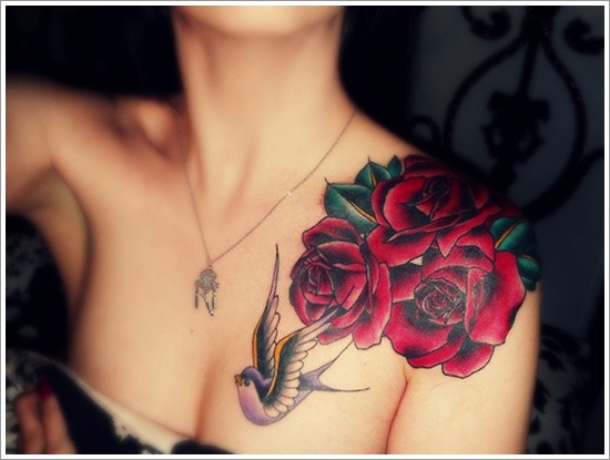 Wonderful painted big roses with bird tattoo on chest and shoulder