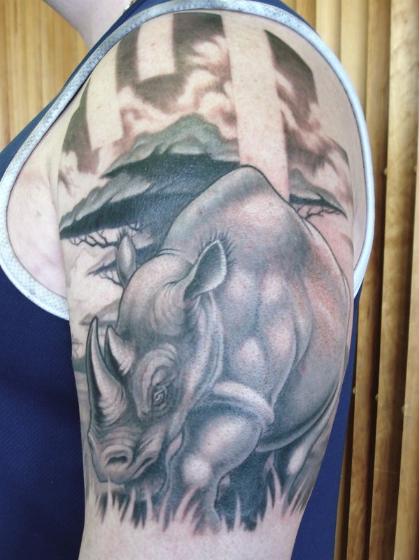 Tatuaje en el brazo,
rinoceronte en la hierba