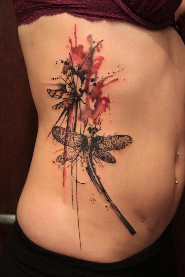 Wonderful watercolor dragonfly tattoo on ribs