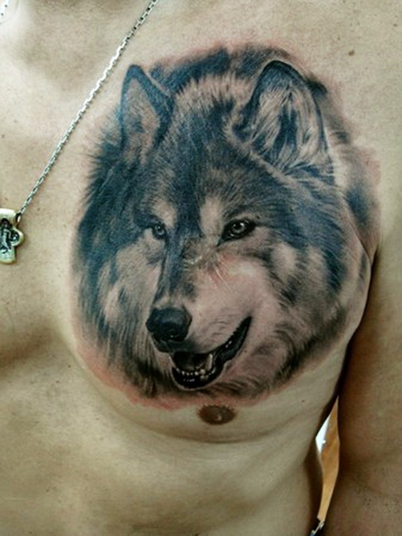Wonderful wolf face tattoo on boys chest