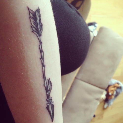 Wooden tribal indian arrow tattoo with feathers