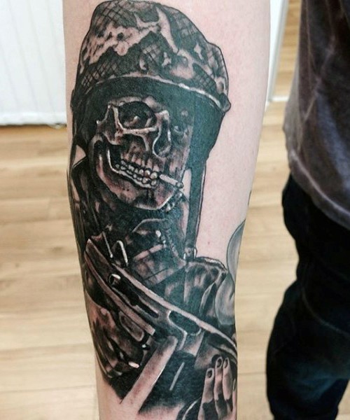 WW2 themed illustrative style forearm tattoo of creepy soldier