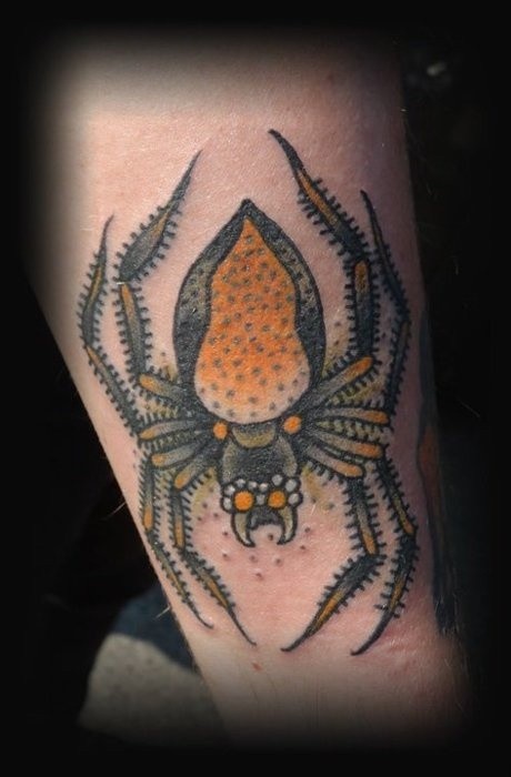 Yellow spider tattoo on arm
