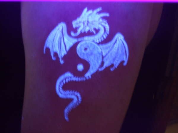 Yin yang and dragon black light style tattoo