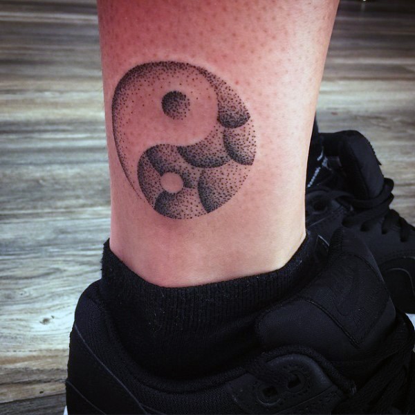 Yin Yang symbol dotted tattoo on ankle