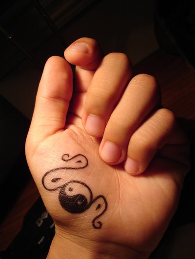 Yin yang symbol on the hand