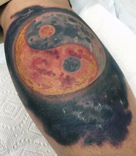 Yin Yang symbol shaped big planet tattoo on leg