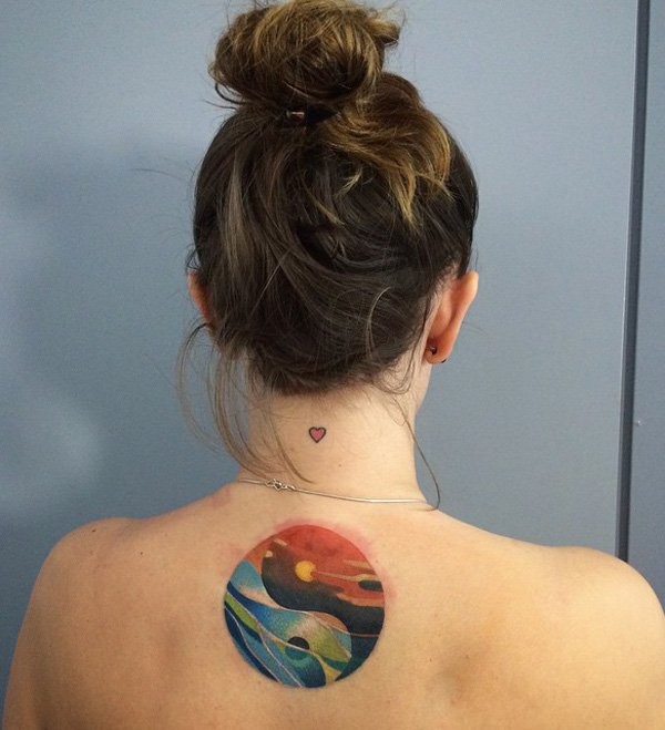 Yin Yang symbol shaped colored back tattoo stylized with sea