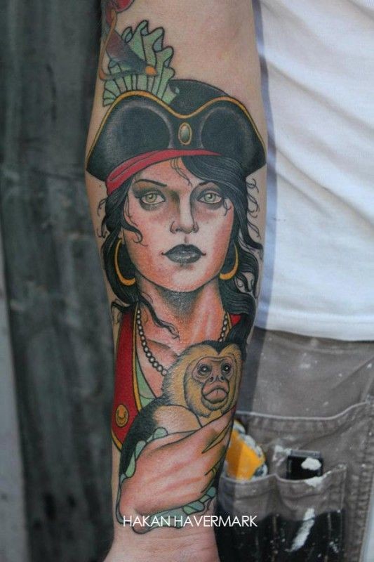 Young woman with a monkey pirate tattoo by hakan havermark